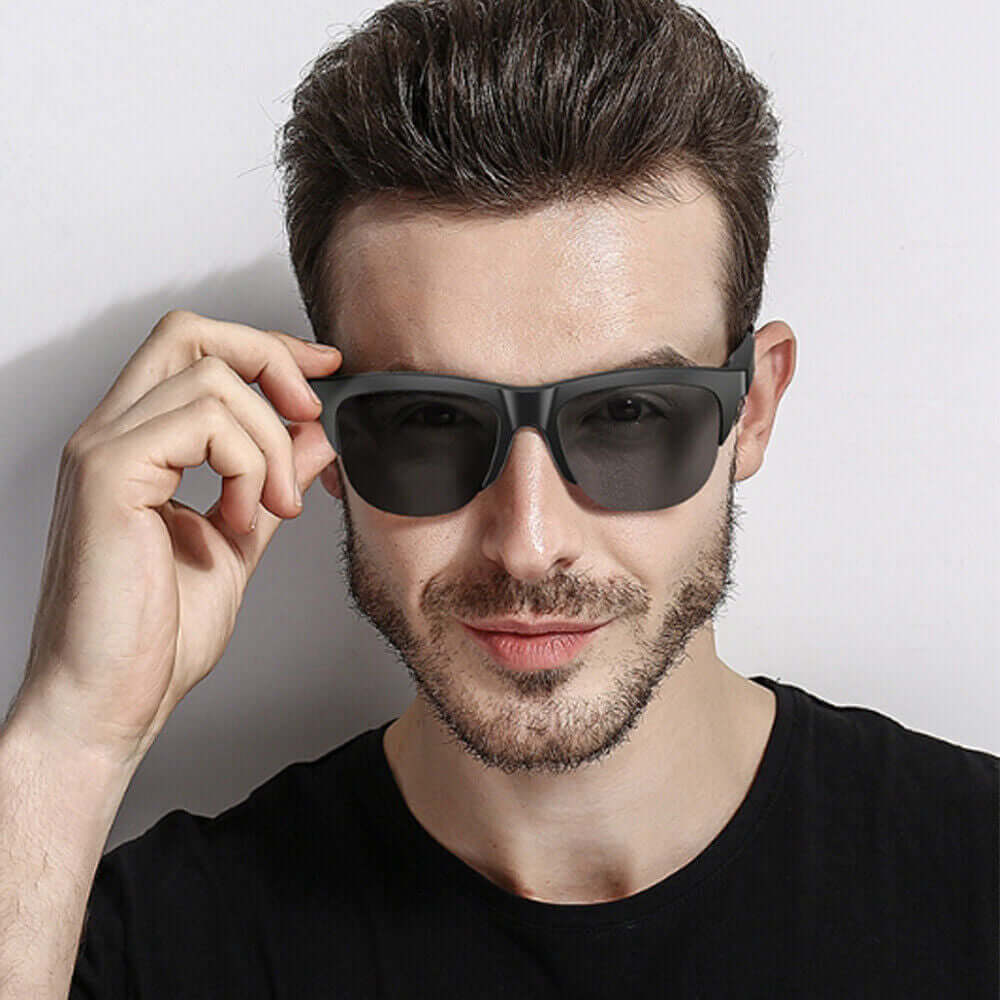 Man wearing Wireless Bluetooth 5.3 smart glasses with a stylish design and dark lenses.